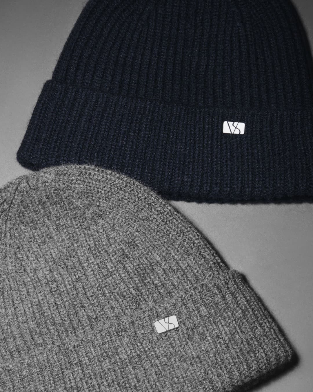 Detailed view of grey and navy cashmere merino wool blend beanies from Varsity headwear