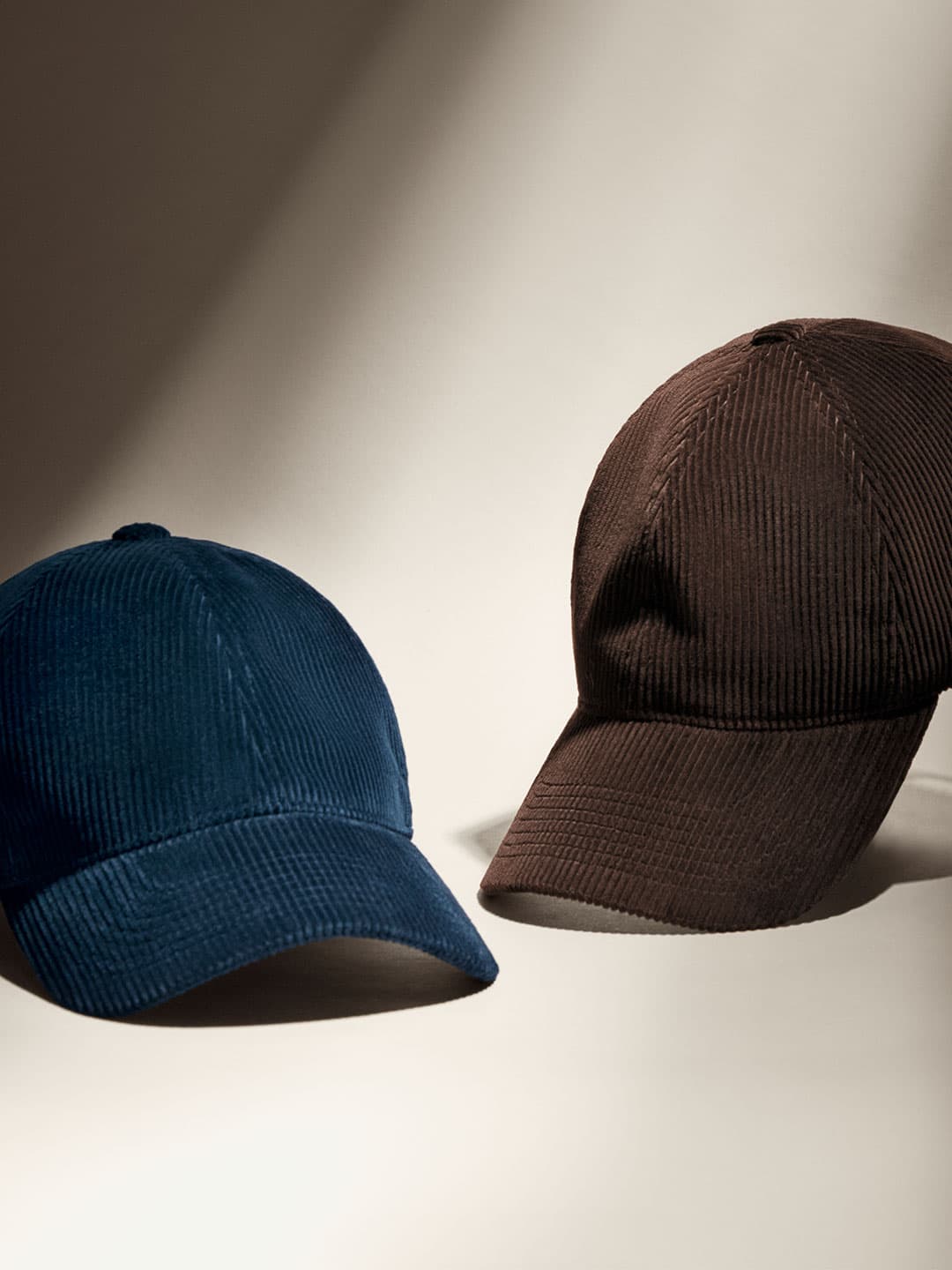 Front view of blue and brown corduroy caps from varsity headwear